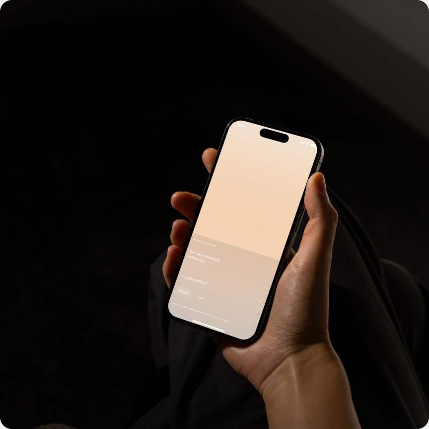 Hand holding a phone running the Flow app