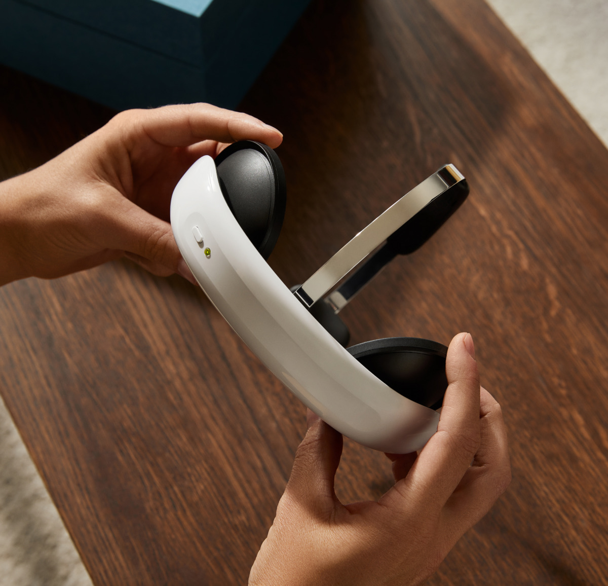 Hands holding the white Flow headset