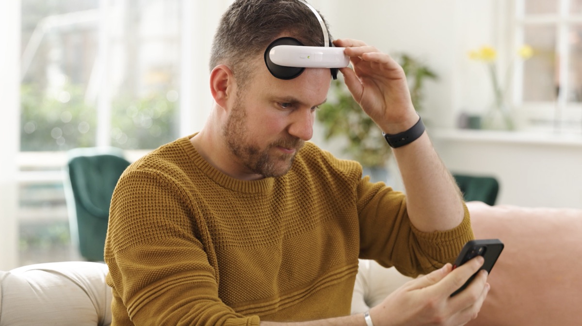 Jon, a Flow user, at home wearing the Flow headset